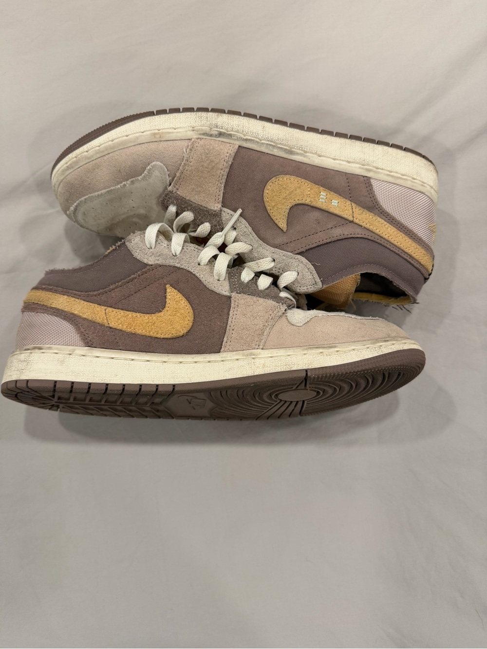 Jordan 1 Low SE. Low-Top Suede Sneakers in Taupe with Mustard Swoosh